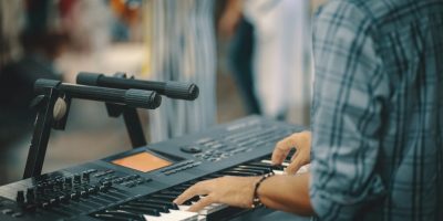 person playing electronic keyboard