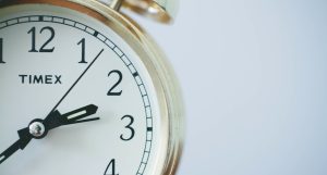 round Timex analog clock at 2:33