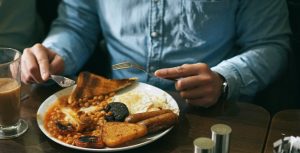 person eating bread with beans